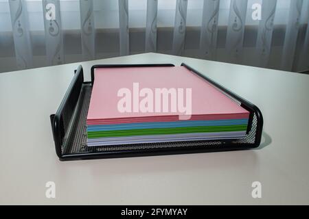 Zurich, Switzerland - June 13, 2020: The drawer with a pile of multicolored photocopy paper. Stock Photo