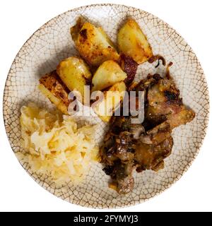 Appetizing fried rabbit liver with potatoes and grated vegetables. Isolated over white background Stock Photo