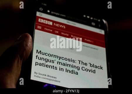 mucormycosis News on the phone.Mobile phone in hands. selective focus and chromatic aberration effects. Stock Photo