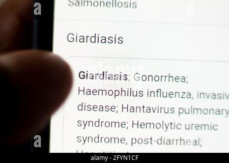 Giardiasis News on the phone.Mobile phone in hands. selective focus and chromatic aberration effects. Stock Photo