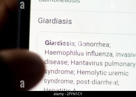 Giardiasis News on the phone.Mobile phone in hands. selective focus and chromatic aberration effects. Stock Photo