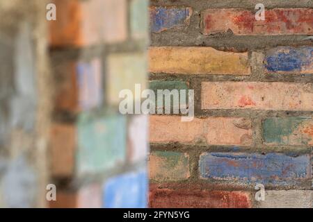 Background image of a colorful wall made of bricks in different colors Stock Photo