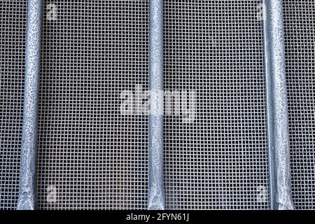 Background image of a grey metal mesh window in Morcote, Switzerland Stock Photo