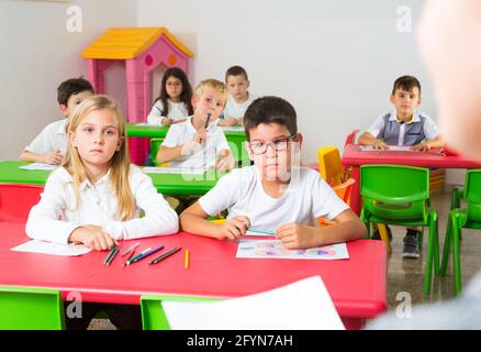 View from teacher of schoolchildren of primary school at desks in classroom Stock Photo