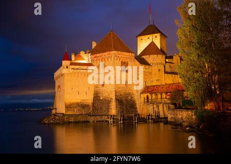 Impressive night view of medieval castle of Chateau de Chillon on Geneva Lake, canton of Vaud, Switzerland Stock Photo