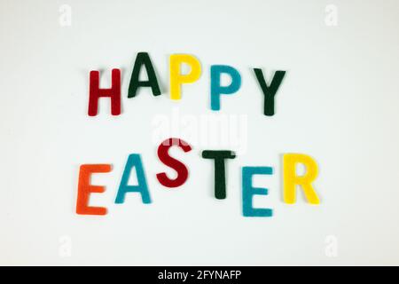 Happy Easter greeting card with colorful inscription on the white background Stock Photo