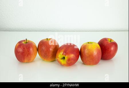 Five red-yellow juicy ripe apples on the white background Stock Photo
