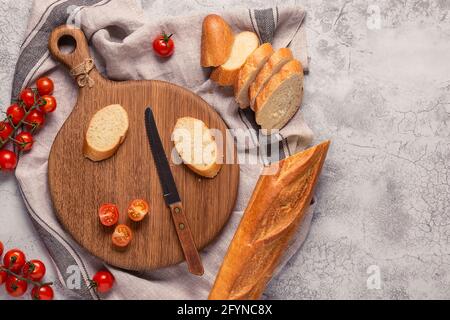 board, bread and tomatoes for making sandwiches Stock Photo