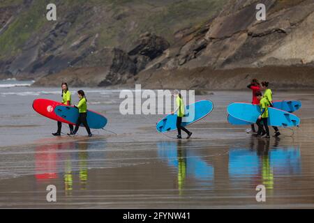 Newgale, Pembrokeshire, Wales, UK. 29 May, 2021. People go surfing off Newgale beach in Pembrokeshire as the bank holiday weekend begins. Credit: Gruffydd Ll. Thomas/Alamy Live News Stock Photo