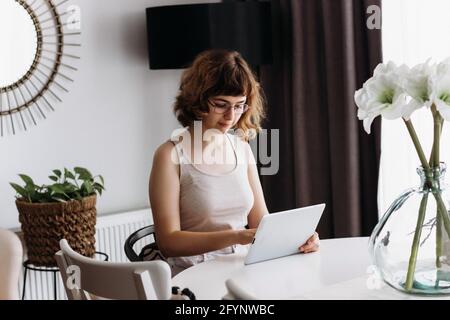 Young girl studying online. Home education and homeschooling. Online lessons on tablet Stock Photo