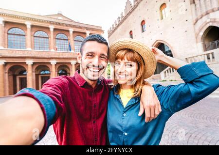 Young boyfriend and girlfriend in love having fun taking selfie at old town tour - Wanderlust life style travel concept with tourist couple Stock Photo
