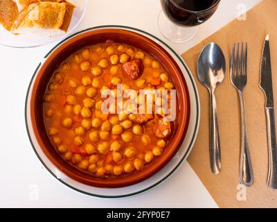 Garbanzos a la riojana, a spanish chickpeas stew with ham in a restaurant Stock Photo