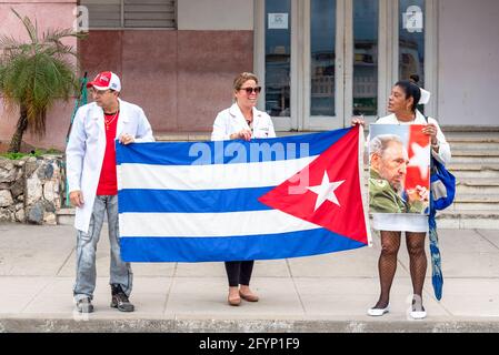 Santa Clara, Villa Clara, Cuba-January 6, 2019: Doctors and health care personnel waits for the Victory Caravan outside the Santa Clara clinic in the Stock Photo