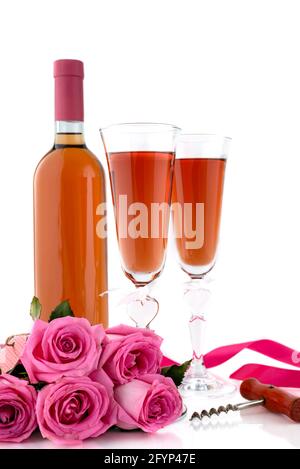 Valentine's Day concept. Two glasses of wine, pink roses and corkscrew on a white background. Selective focus. Stock Photo