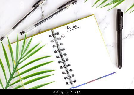To do list in the planning notepad with the checklist and copy space on light background. Office management and education reminder concept. Stock Photo