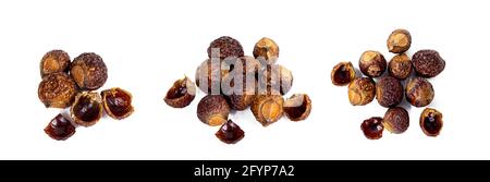 Brown dry soap nuts (Soapberries, Sapindus Mukorossi) for organic laundry and gentle natural skin care set isolated on white background. Stock Photo