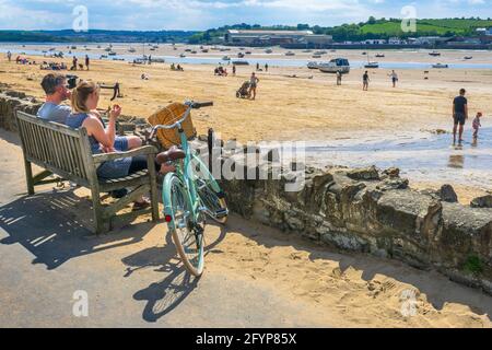 Instow, North Devon, England. Saturday 29th May 2021. UK Weather. After a week of grey skies in North Devon, a bright start to Bank Holiday weekend tempts hundreds of tourists to the North Devon coast to enjoy the beach at the picturesque coastal village of Instow. Credit: Terry Mathews/Alamy Live News Stock Photo