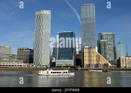 Canary Wharf Estate with Thames Sightseeing cruise and Uber Thames Clippers ferryboat, Newfoundland Place, The Landmark Pinnacle and One Bank Street, Stock Photo