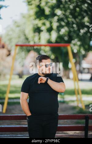 Stylish male wearing a smartwatch is using a voice command recorder Stock Photo