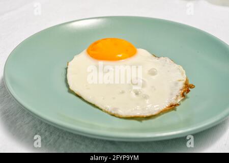 scrambled eggs on a blue plate close up. Stock Photo