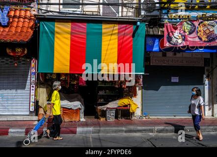 Two women walk past a colorful shopfront in Chinatown, Bangkok, Thailand Stock Photo