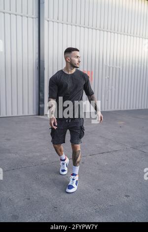 Young man with tattoos in cool casual style Stock Photo