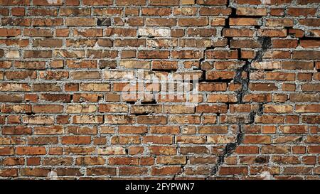 Creative background red brick wall with crack. Antique brick wall. Copy space Stock Photo