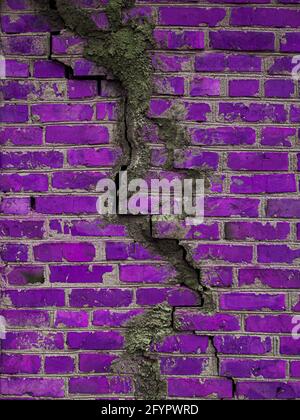 Texture of a brick wall with cracks in purple. Destroyed ancient wall violet. Brick background copy space. Stock Photo