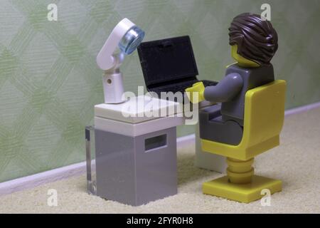 LUTON, UNITED KINGDOM - May 20, 2020: Working from home asrepresented with Lego figures Stock Photo