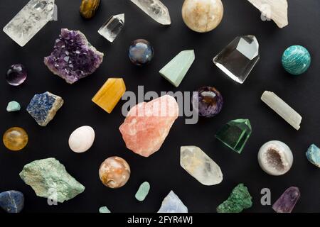 Crystal stones set on black background. Gemstones and crystals on dark background. Background of healing minerals Stock Photo