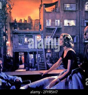 REAR WINDOW 1954 Paramount Pictures film. Promotional photo showing James Stewart, Grace Kelly and producer Alfred Hitchcock at right Stock Photo