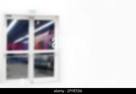 white wall with it closed door, defocused Stock Photo