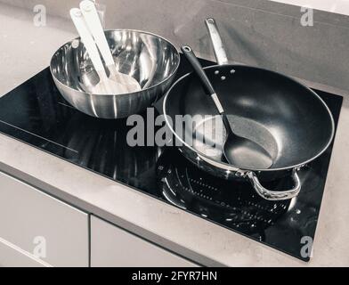 frying pans on the electric induction cooker Stock Photo