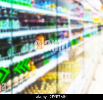 defocused supermarket refrigerators with drinks Stock Photo