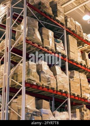 overloaded vertical shelves of warehouse Stock Photo