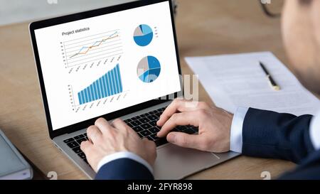 Business leader analyzing financial sales report, reviewing marketing research Stock Photo