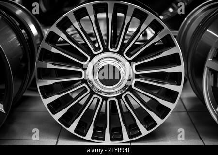 Black alloy wheels for premium cars, close-up. Purchase and replacement of autodisks. Stock Photo