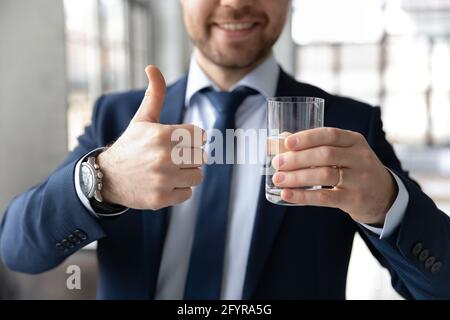 Happy businessman recommending drinking fresh pure water for refreshment Stock Photo