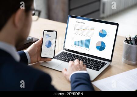 Business marketer using professional app for marketing data analyzing Stock Photo