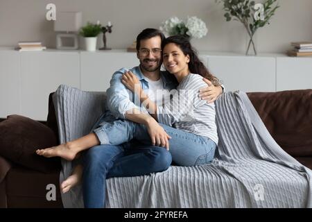 Portrait of smiling multiethnic couple relax at home Stock Photo