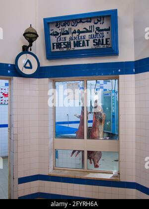 Fresh meat hangs in the window of a butcher at the main, old, central market, souq, bazaar of Nizwa. In Oman. Stock Photo