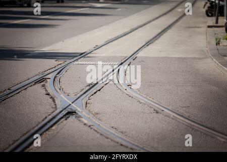 Picture of a switch at a junction between several tram lines on an asphalted street of an urban downtown. Stock Photo