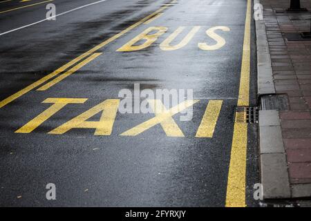 Picture of a bus and taxi lane marking on an asphalted road in belgrade, Serbia. A bus lane or bus-only lane is a lane restricted to buses, often on c