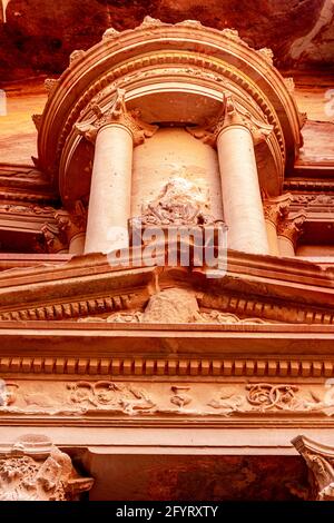 The central tholos, frieze, acroterion of the upper level of the Treasury, where Bedouin believed the treasure was hidden by Egyptian Pharaoh, Petra, Stock Photo