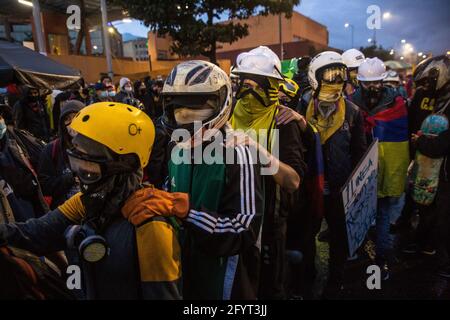 A group from the first line getting ready for the confrontation with the police during the demonstration.On the 28th of May, a month after the national strike first began, protesters, continue to demonstrate on the streets of Bogotá and all over the country to oppose government policies. At the capital city, multiple demonstrations and marches took places during the day, with thousands of people participating in the strike. At Plaza de Los Heroes (Heros Square), one of the concentration point in Bogotá, more than 4.000 people gathered. Events such as concerts, performances and speeches create Stock Photo