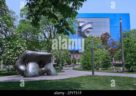 Toronto, Canada - May 23, 2021: People relax on the grass in Grange Park with a Henry Moore scuplpture, with Art Gallery of Ontario designed by Frank Stock Photo