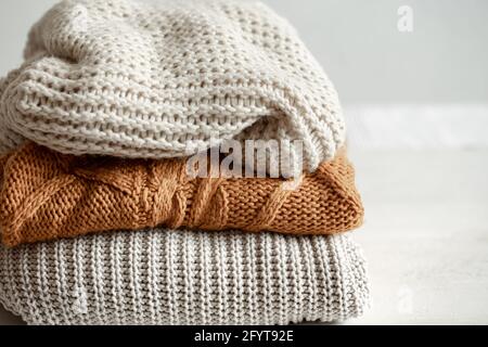 A stack of neatly folded warm knitwear, wool close up. Stock Photo