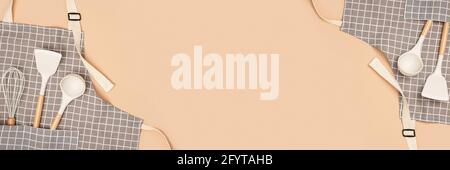 Cooking background. Flat kitchen accessories. Apron and silicone cooking  utensil with wooden handle on beige background with copy space. Top view  Flat Stock Photo - Alamy