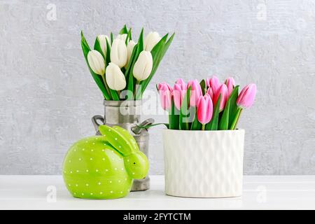 Easter decoration with green rabbit and tulips. Postcard motif, copy space. Stock Photo