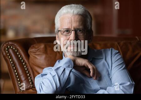 Portrait of older grey haired man in glasses Stock Photo
